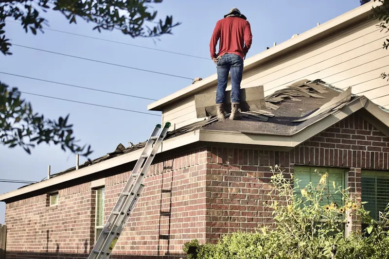 Professional roofer working on a residential roof in Lynchburg, Moore County
